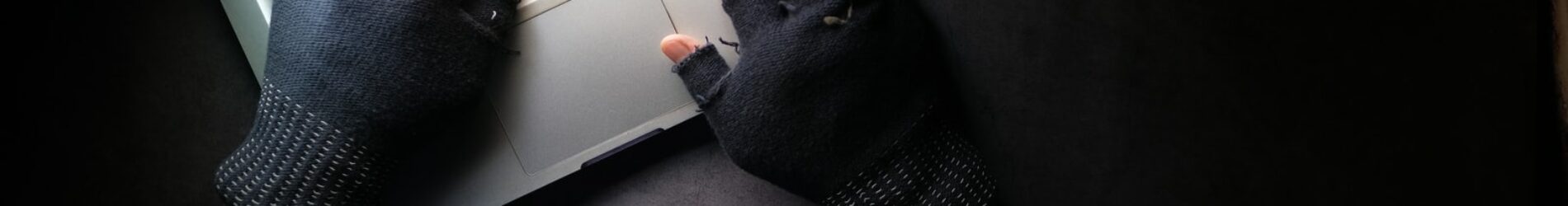 person in black long sleeve shirt using macbook pro